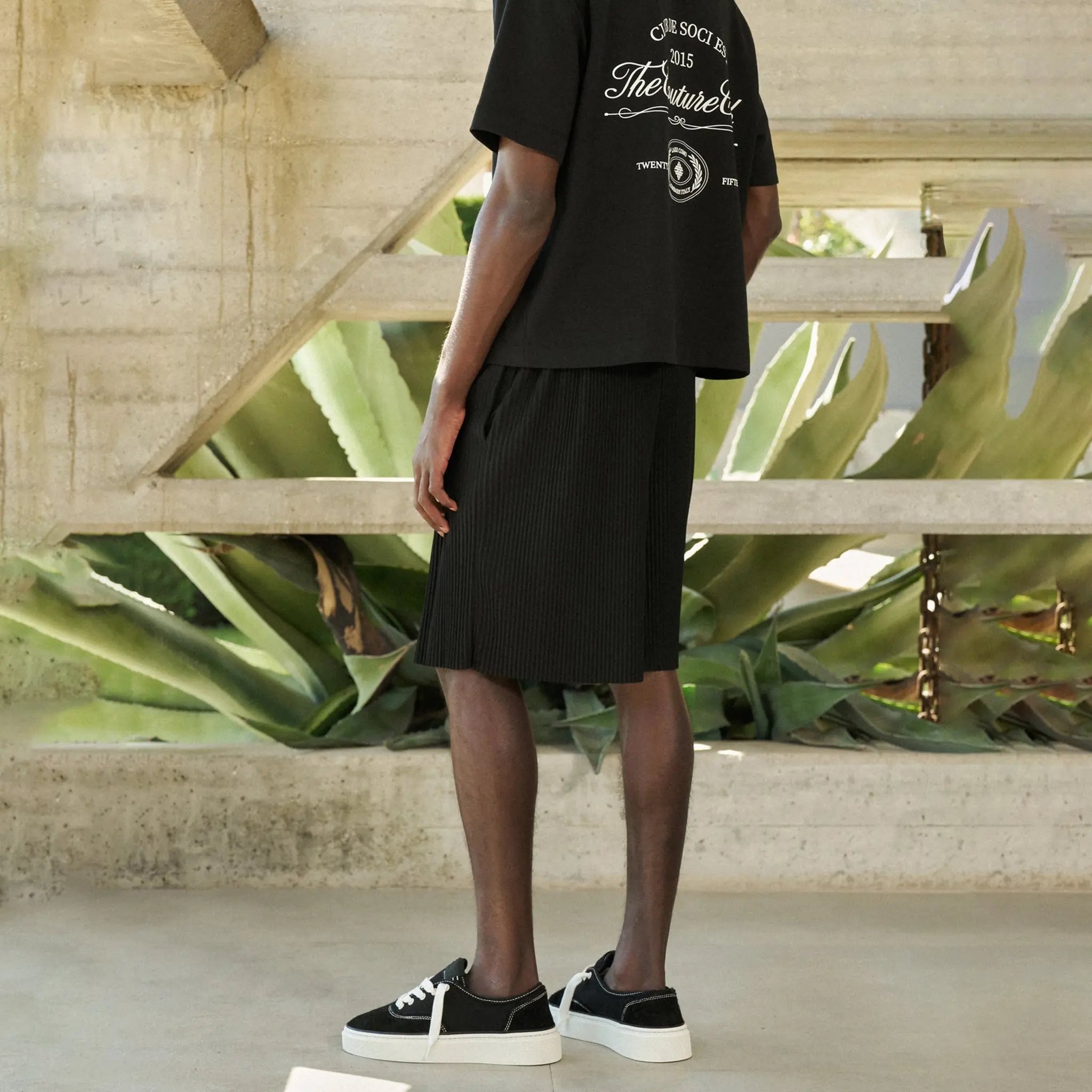 Back Side View of The Couture Club Plisse Black Shorts